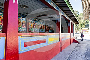 Painted Buddha images in the temple with tourist in Tibetan Buddhism Temple in Sikkim, India