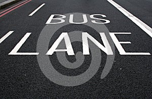 Painted bus lane sign on road