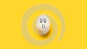 Painted chicken egg with shocked emoji