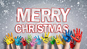 Painted children hands with smileys with `Merry christmas ` message