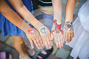 Painted children& x27;s hands in different colors with smilies