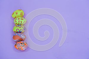 THe painted colorful Easter egg in the basket on the pink background copyspace
