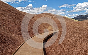 The Painted Cove boardwalk trail twists through the claystone hills at Painted Hills John Day Fossil Beds Natl Monument, OR, USA