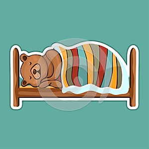 Painted cute funny brown bear in hibernation lying on the bed covered with blanket and sleeping sticker, colorful hand drawing