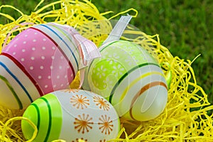 Painted decorated Easter eggs on yellow straw