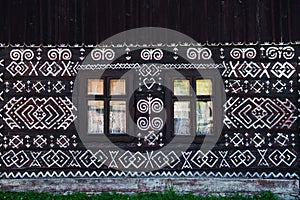 Painted decorations on wall of log house in Cicmany, Slovakia