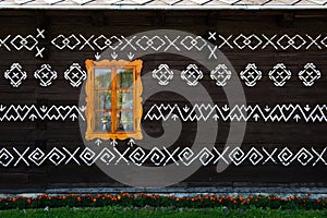 Painted decorations on wall of log house in Cicmany, Slovakia