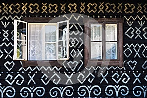 Painted decorations on wall of log house in Cicmany, Slovakia