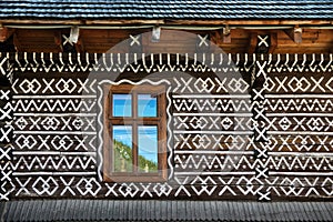 Painted decorations on wall of log house in Cicmany, Slovakia