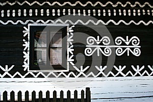 Painted decorations on wall of log house in Cicmany, Slovakia