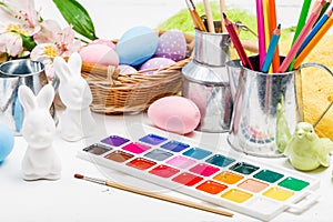 Painted decorative easter eggs, brushes, palette and paints