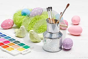 Painted decorative easter eggs, brushes, palette and paints