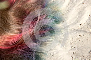 Painted in different colors hair on the sand.