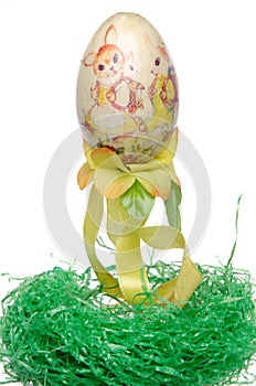 Painted easter egg on a green nest