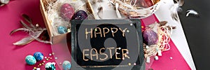 Painted Easter eggs in cardboard box and basket