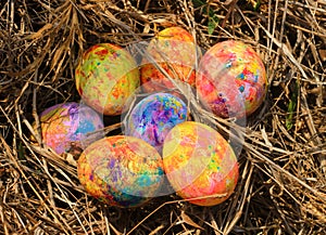 Painted Easter eggs hidden on the grass, ready for the easter egg hunt traditional play game