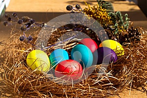 Painted Easter eggs in a nest of straw.  Easter still life