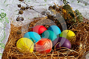 Painted Easter eggs in a nest of straw.  Easter still life