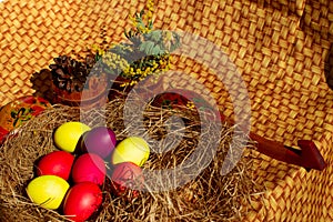 Painted Easter eggs in a nest of straw. Easter still life