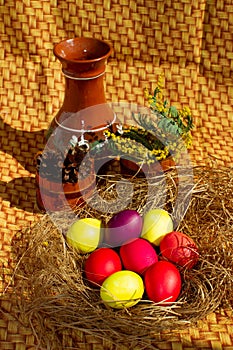 Painted Easter eggs in a nest of straw. Easter still life