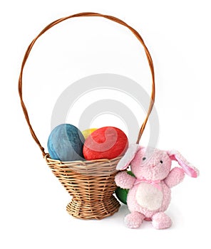 Painted Easter eggs and a rabbit in a basket