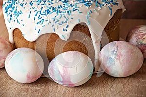 Painted eggs. Easter cake on table. Easter cake with sprinkles on glaze. Happy easter. Dessert. Backery. Egg hunt. Traditional