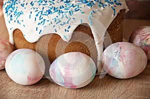 Painted eggs. Easter cake on table. Easter cake with sprinkles on glaze. Happy easter. Dessert. Backery. Egg hunt. Traditional photo