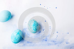 Painted eggs flat lay on a white background. Easter and spring composition. Copy space.