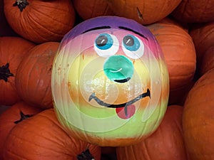 Painted Face Pumpkin Sitting In A Group Of Pumpkins