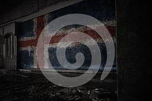 Painted flag of iceland on the dirty old wall in an abandoned ruined house