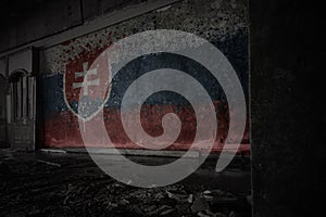 Painted flag of slovakia on the dirty old wall in an abandoned ruined house