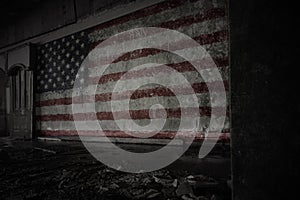 Painted flag of united states of america on the dirty old wall in an abandoned ruined house