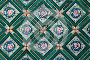 Painted geometric and floral patterns decorate the ceiling of a palace in Beijing (China)