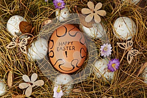 Painted `Happy Easter` egg in easter wreath
