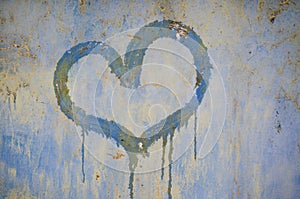 Painted heart on a rusty iron background