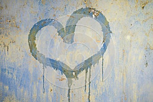 Painted heart on a rusty iron background