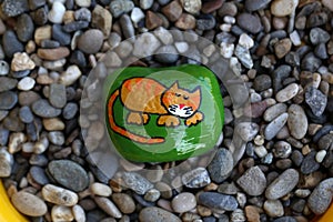 The painted hiking stone is left on the walking path for passersby to see