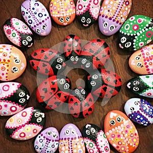 Painted Kindness Rocks Decorated like Colorful Bugs in a Circular Design