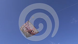 Painted kite and flag in the sky