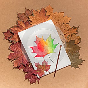 Painted maple leaf on a white sheet