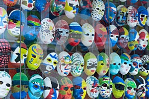 Painted masks behind glass
