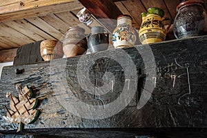 Painted mugs as decoration on an old press in the wine cellar