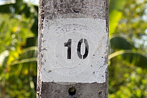 Painted number ten (10) on a concrete column