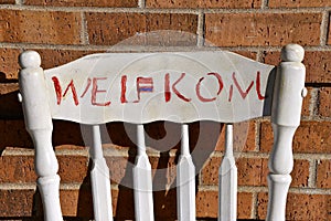 Old chair with a `WELKOM` sign