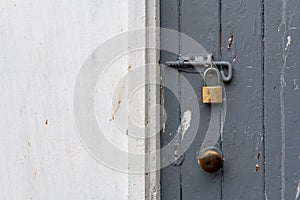 Painted old wooden door bolted shut and locked