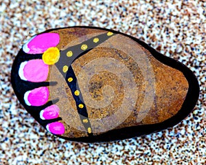 Painted pebble foot sandal.