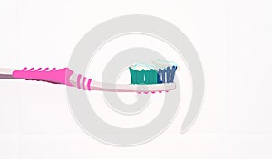 Painted pink toothbrush with toothpaste