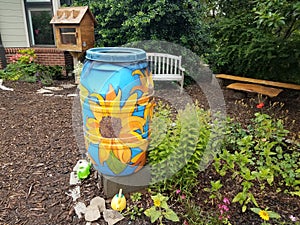 Painted rain barrel and garden