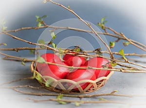 Painted red yaica symbol of faith and God`s will, red Easter yaica, easter, faith, tree twigs and easter