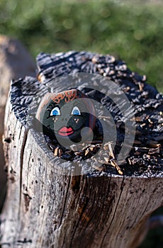 Painted rock with cute drawn face